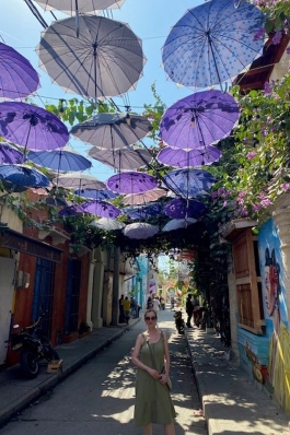 Susi Robichaux on a street topped with purple parasols in Cartagena, Colombia