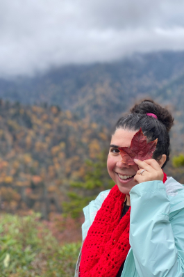 Yasaman Roostaeian holds up a maple leaf in the Great Smoky Mountains