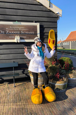 Jackie Contaldo tries on oversized clogs in the Netherlands