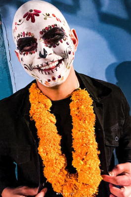Mike Brock in full makeup and a marigold necklace for Día de los Muertos in Oaxaca, Mexico
