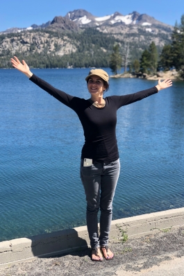 Elodie standing in front of a lake