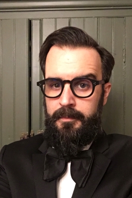 Patrick Rodgers headshot with black glasses