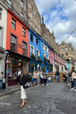 Andrea Valentini standing in front of colorful buildings in Scotland
