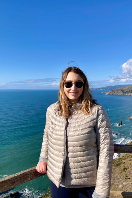Ashley Hughes in front of a beach