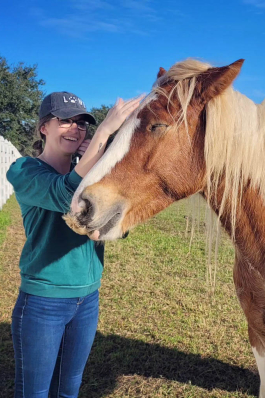 Jessica Payne petting a horse