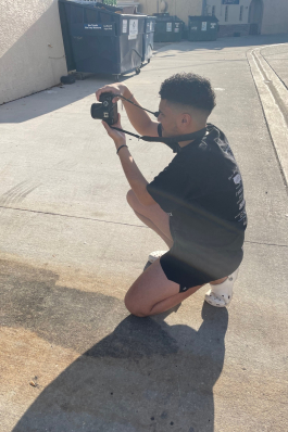 A picture of Andy taking a photo with a DSLR camera