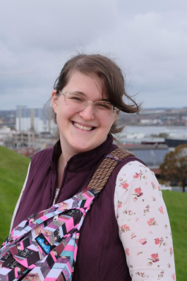 A photo of Katie with a city backdrop