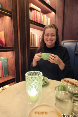 A photo of Holly drinking a cup of coffee