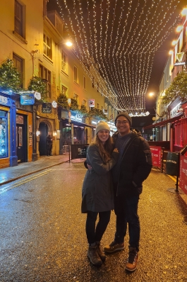A photo of Holly and her husband in a downtown area.