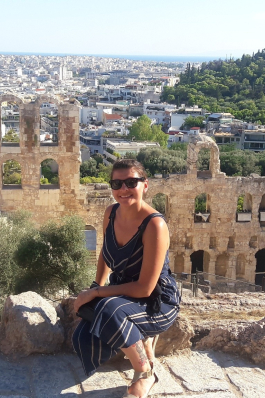 A photo of Nicole in front of ruins in Athens. 