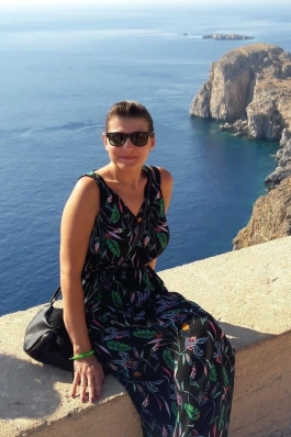 A photo of Nicole near the ocean in Greece. 