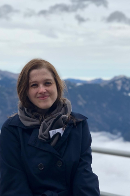A photo of Angela in front of German mountains. 