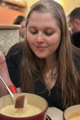 A photo of Angela eating soup in Switzerland.