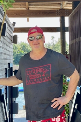 A photo of Richard with his hand on his hip. 