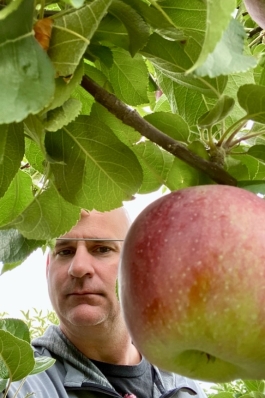 A photo of Richard next to an apple. 