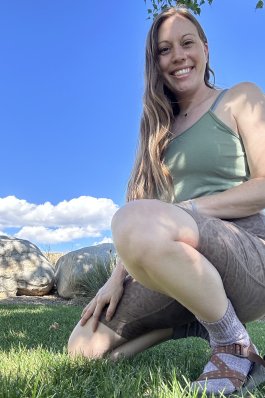 A photo of Andi crouching down. 