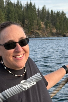 A photo of Lori overlooking a lake. 