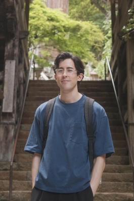 A photo of James behind stairs in Kyoto. 