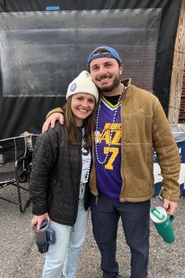 A photo of Victoria and someone with a Jazz jersey at Mardi Gras