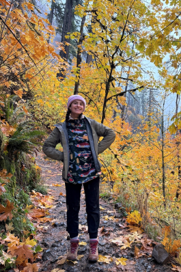 A photo of Kylie in the woods. 