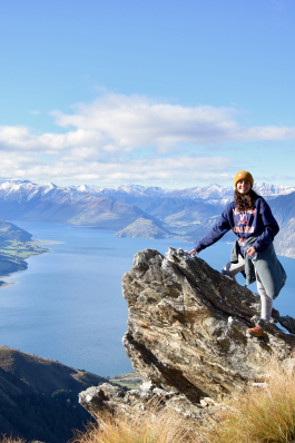 A photo of Kylie standing on a cliff. 