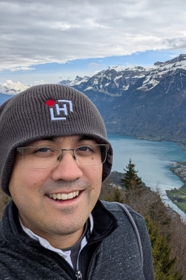 A scenic photo of David near a mountain range.