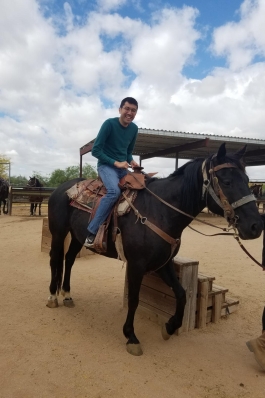 A photo of David on horseback.