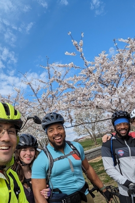 A photo of David and friends biking during cherry blossom season in D.C.