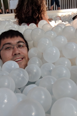 A photo of David in a balloon pit.