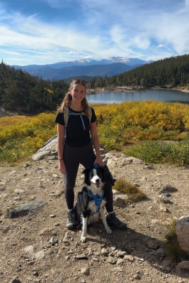 A photo of Taylor on a hike with her dog. 