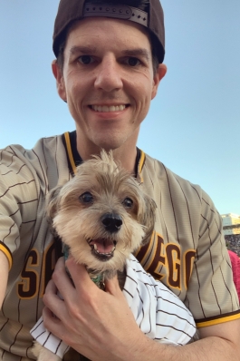 A photo of Michael and his dog at a Padres game. 