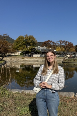 A photo of Emily near a lake in South Korea. 