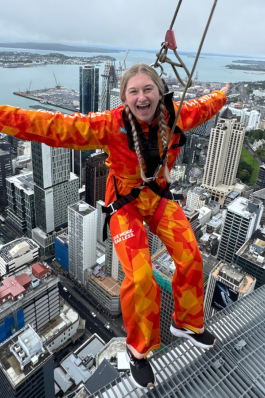 A photo of Kayla leaning off a building in New Zealand