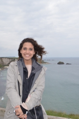 A photo of Tiffany posing in front of the ocean in Ireland. 