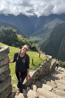 A photo of Micaela near steps in Peru. 