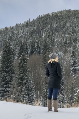 A woman looking on to the distance of the Rockies.