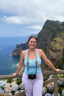 A photo of Rachel posing with her camera. 