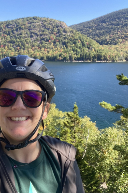 A photo of Whitney biking at Acadia National Park. 