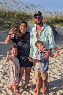 A photo of Whitney and her family on the beach. 