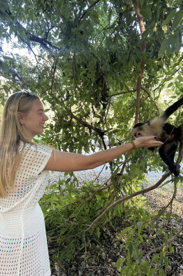 Katherine reaching out to touch a monkey in Costa Rica. 