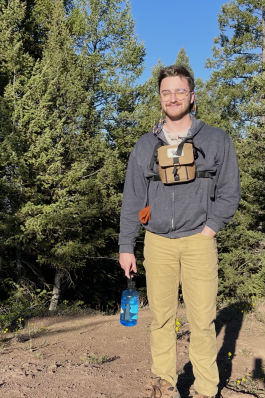 Jack posing in front of shrubs in the Grand Teton. 