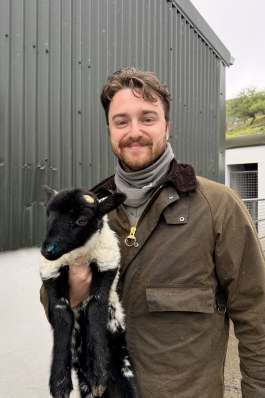 Jack holding a baby goat in Ireland. 