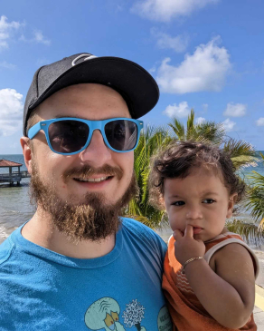 Alex Everingham with child in his arms