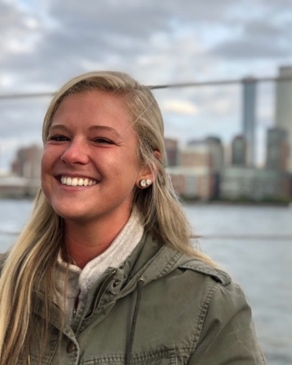 Alyssa Patton with a river and New York City behind her