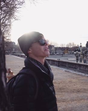 August Erickson looks out at the city on an overcast day in Paris