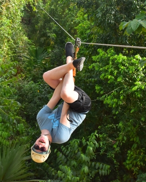 August Erickson hangs upside down while ziplining in Tulum, Mexico