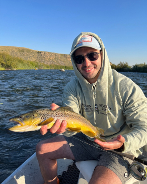 Ben Walton shows off a rainbow trout he caught in Montana