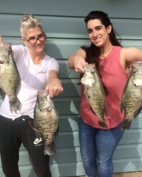 Caitlin Bussey poses with fish she caught