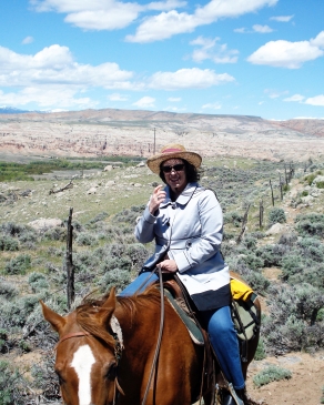 Carrieann Stutz rides a horse in Wyoming
