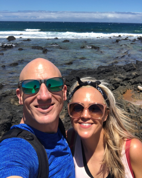 Christine Johnson in front of the rocky shoeline on Kauai